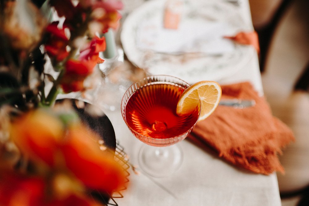 a glass with a drink and a slice of lemon
