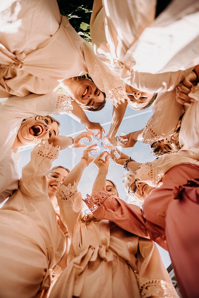 a group of women in a circle cheering